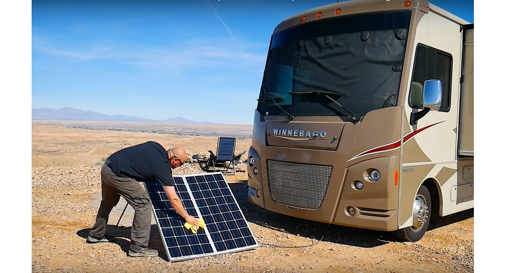 Man cleans portable solar panels