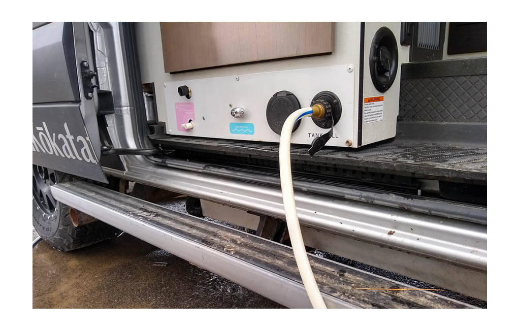 Hose attached to water hook-up on Motorhome.