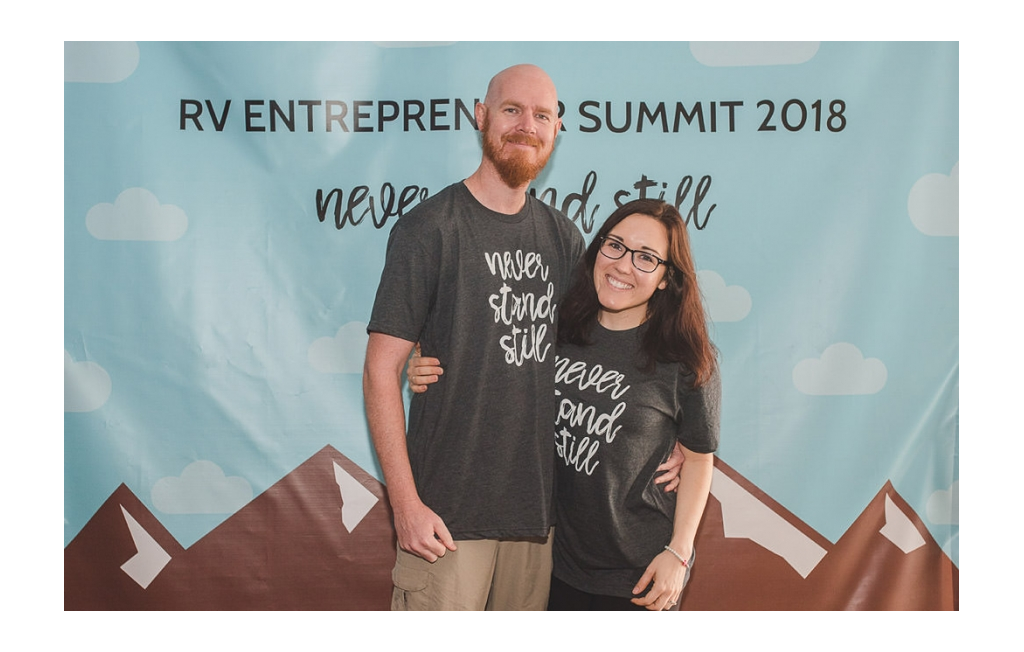Brooke and Buddy in front of the sign at RV Entrepreneur Summit