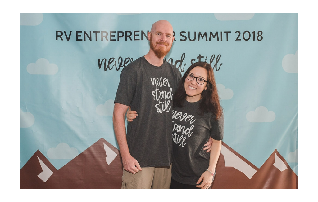 Brooke and Buddy in front of the sign at  RV Entrepreneur Summit