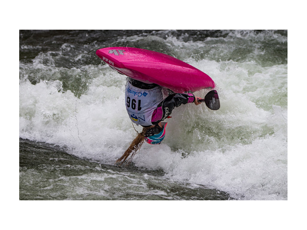 Abby in kayak flipping in air for 2018 Live Lake Maria Freestyle Classic