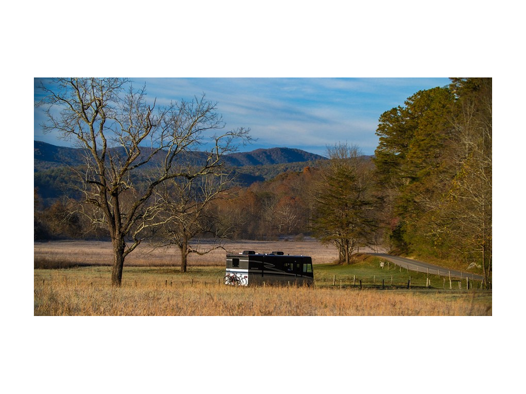 Adventurer parked in large field near trees