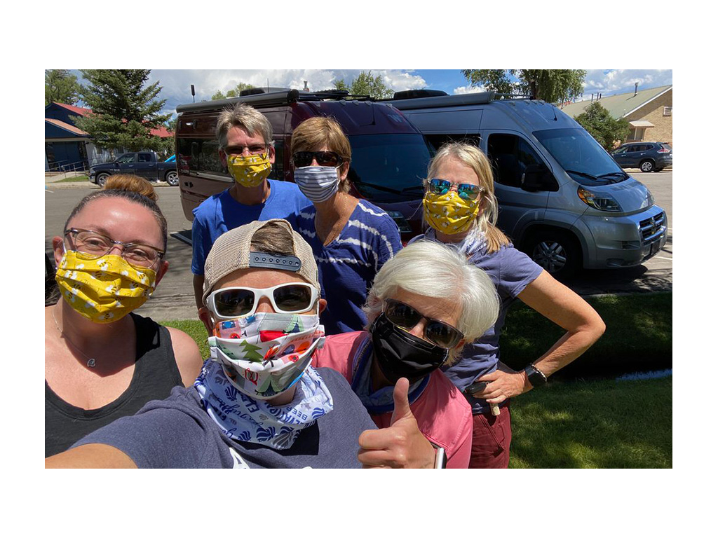 Group of six Travato friends wearing masks