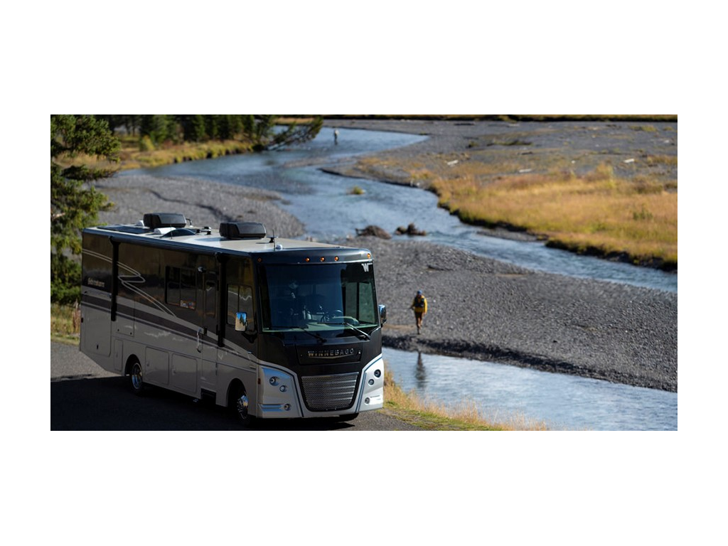 Adventurer parked next to river