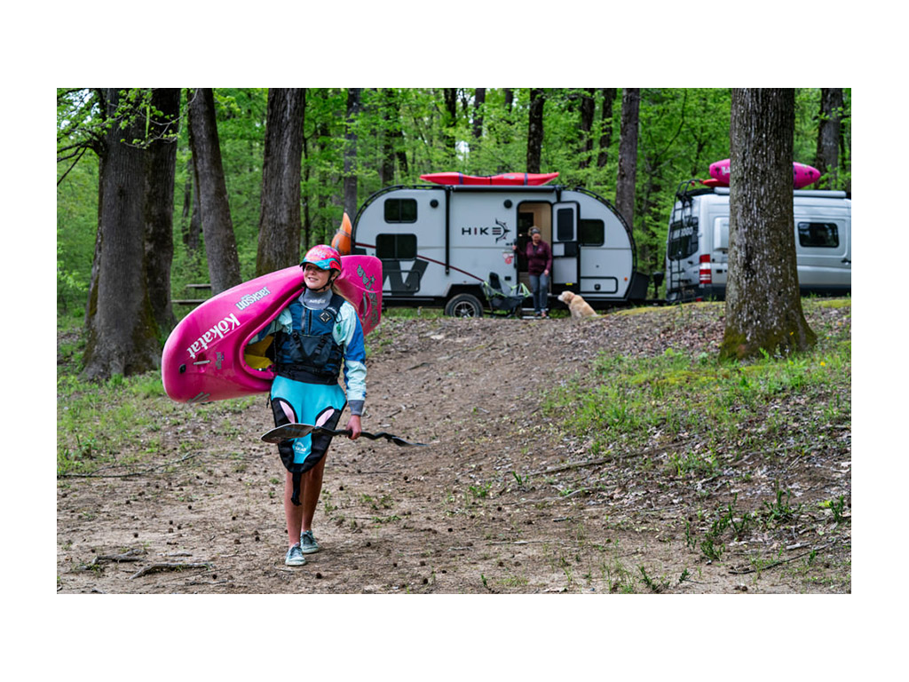Abby carrying kayak away from Winnebago HIKE