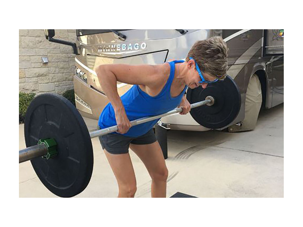 Ann lifting outside of their Winnebago