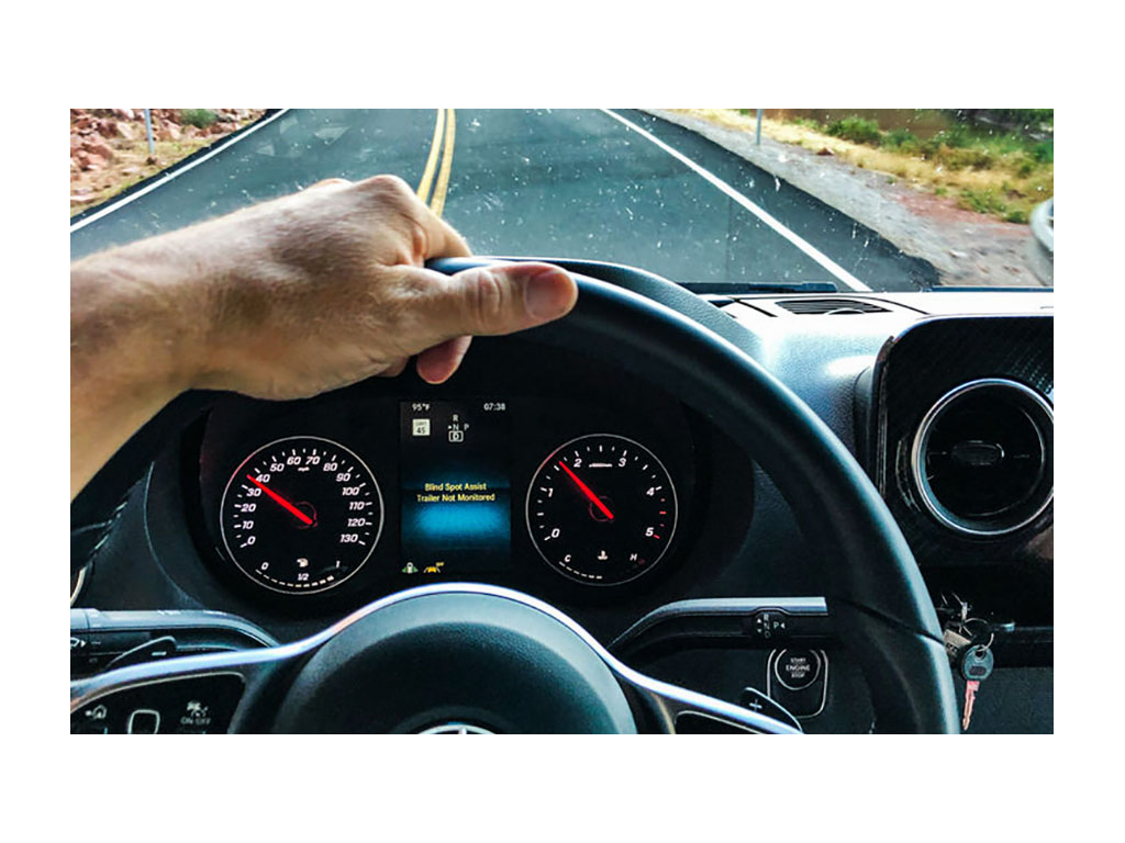 View through windshield of Revel while driving down road.