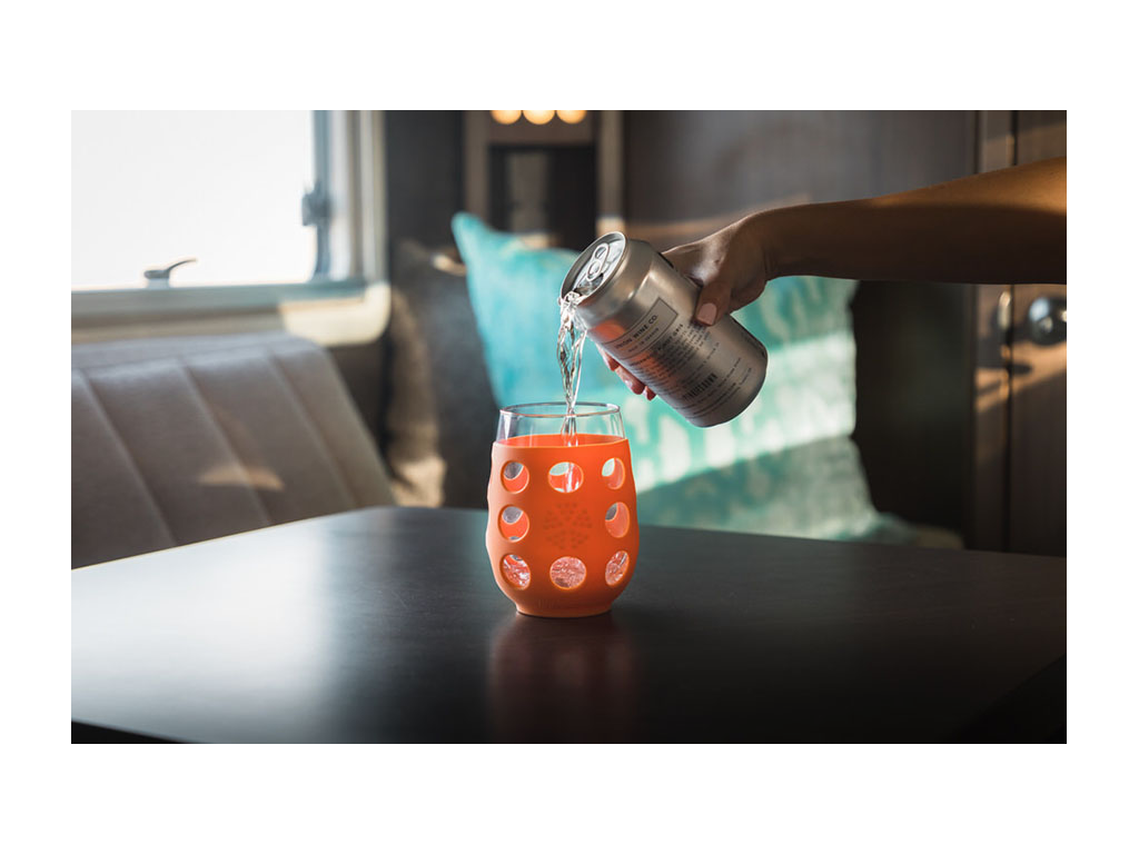 Nadia pouring can of wine into glass