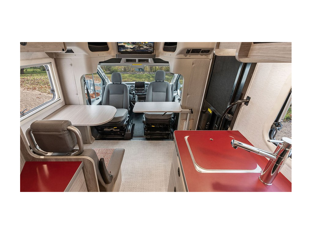 Interior of EKKO from back to front. Driver’s and passenger’s seats are swiveled to face dinette.