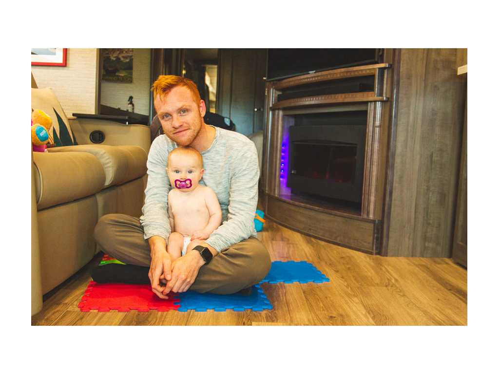 Ellie and Heath sitting on floor of Forza in front of fireplace