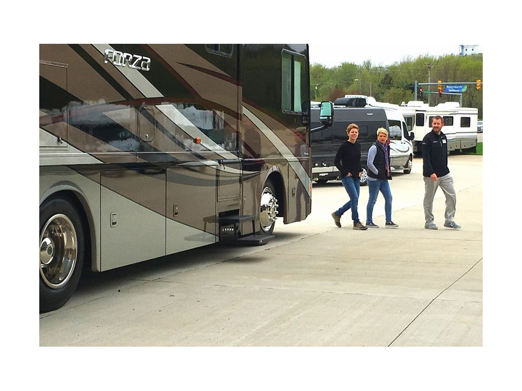 Ann and Lin walking with dealer next to Forza