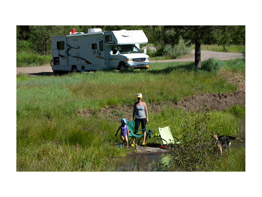 Kelly and daughter in front of their Class C Winnebago Itasca