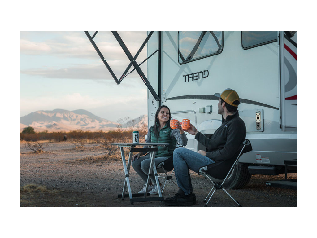 Jon and Nadia sitting outside of Trend at small table drinking wine