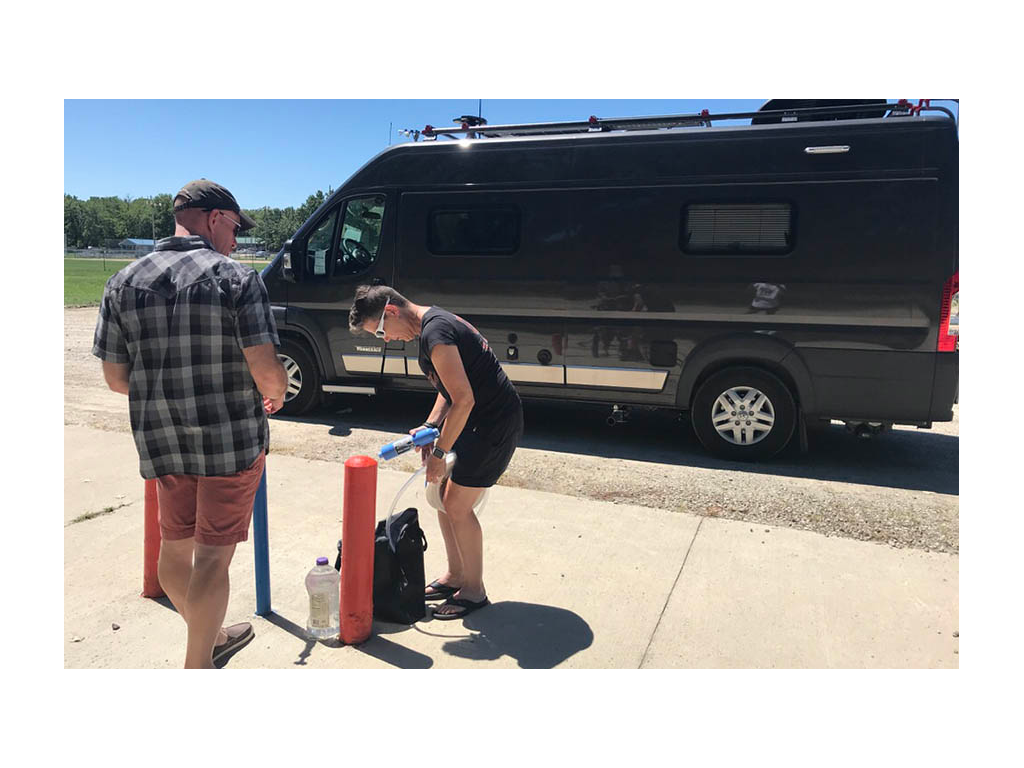 James teaching Noel how to fill fresh water