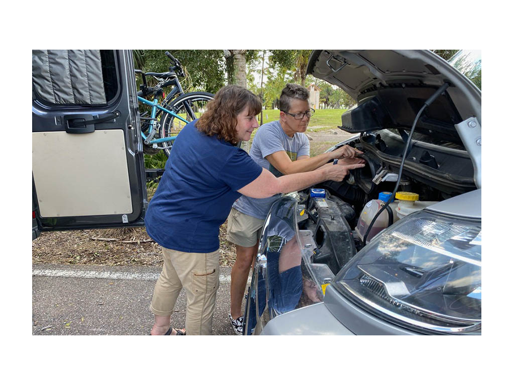 Joni showing Noel how to change air filter