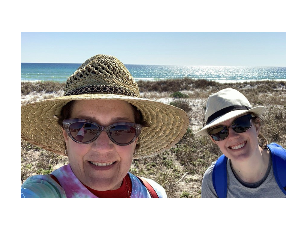 Lindsey and mom smiling for a selfie on the beach