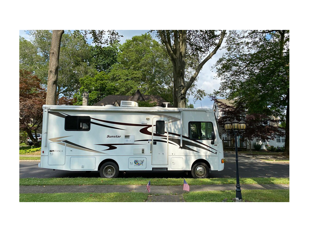 Exterior of Winnebago Sunstar with trees in background