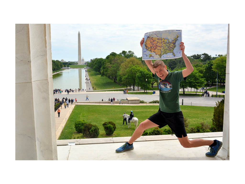 Mikah holding map over head at Lincoln Memorial