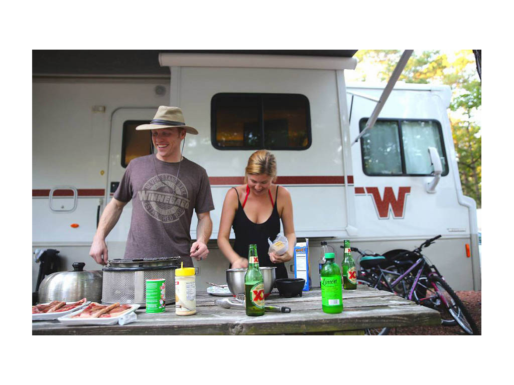 Heath and Alyssa grilling outside RV