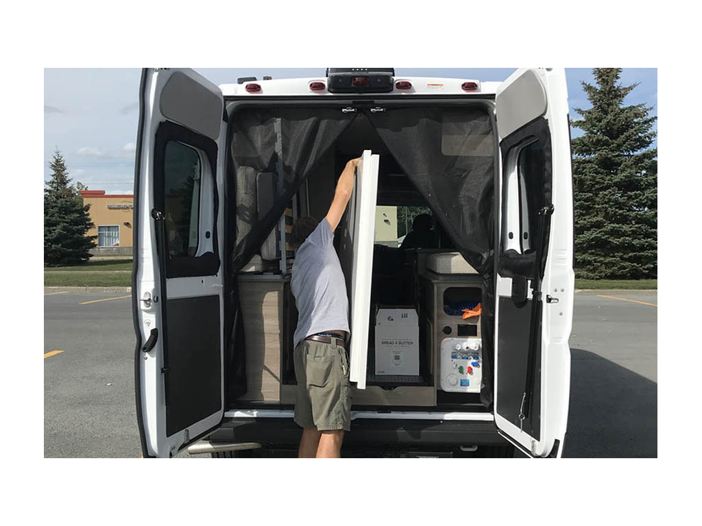 Jason loading two large items into the back of the Solis