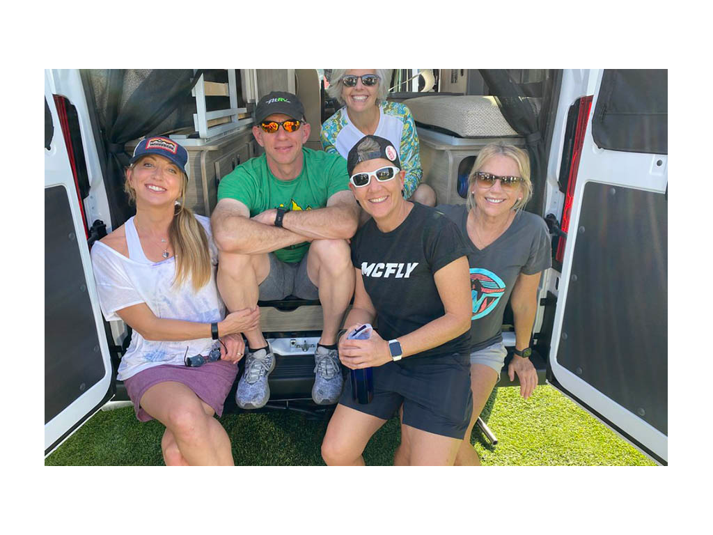 Chris and Noel with three others in attendance at Tampa RV show. All sitting on back of Travato