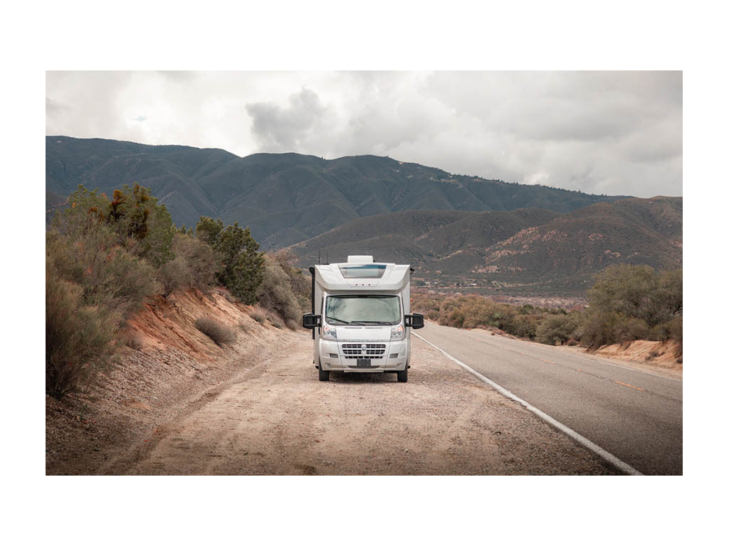 Trend parked on side of the road with mountains in background