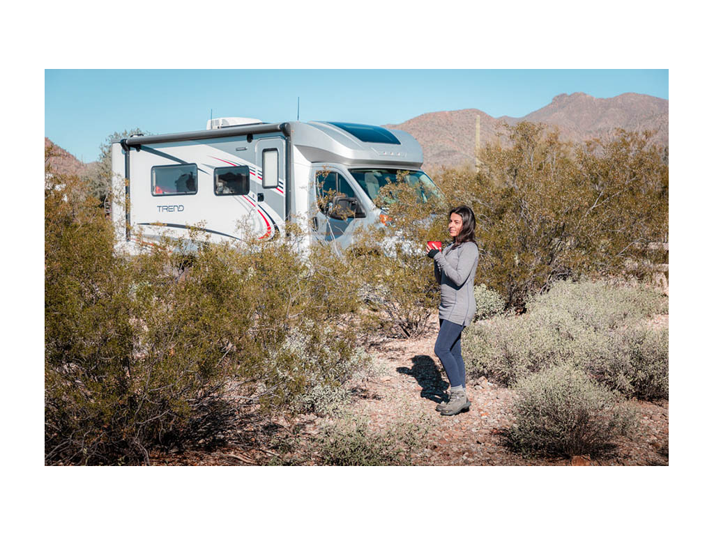 Nadia standing near Trend holding cup of coffee
