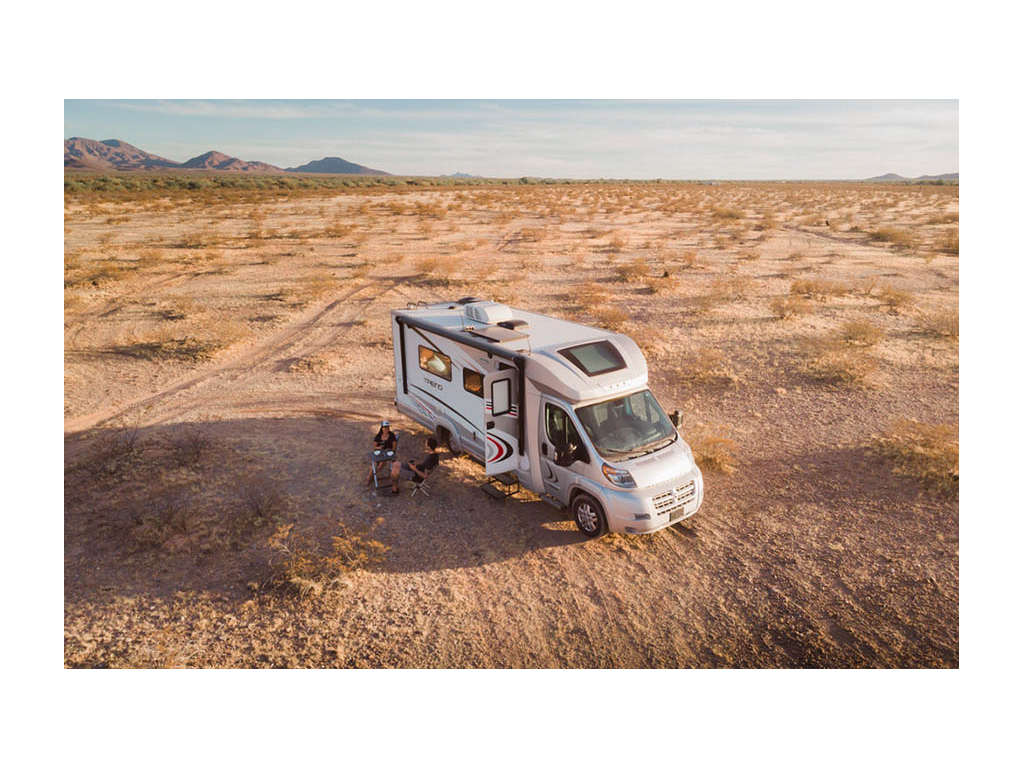 Drone shot of Nadia and Jon sitting outside of Trend while boondocking