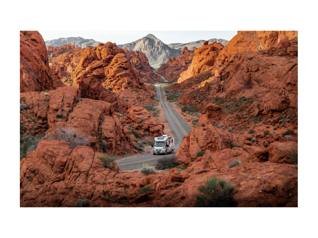 Winnebago Trend driving down winding roads with red mountains all around