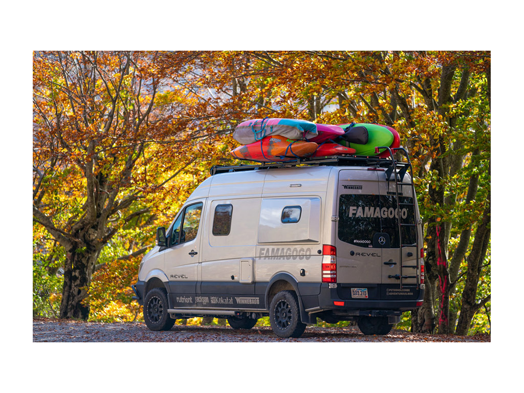 Winnebago Revel loaded with kayaking gear on top