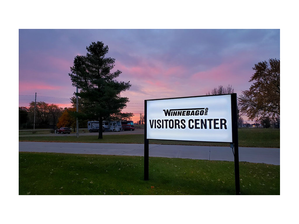 Winnebago Visitors Center sign with pink and purple sunset in background