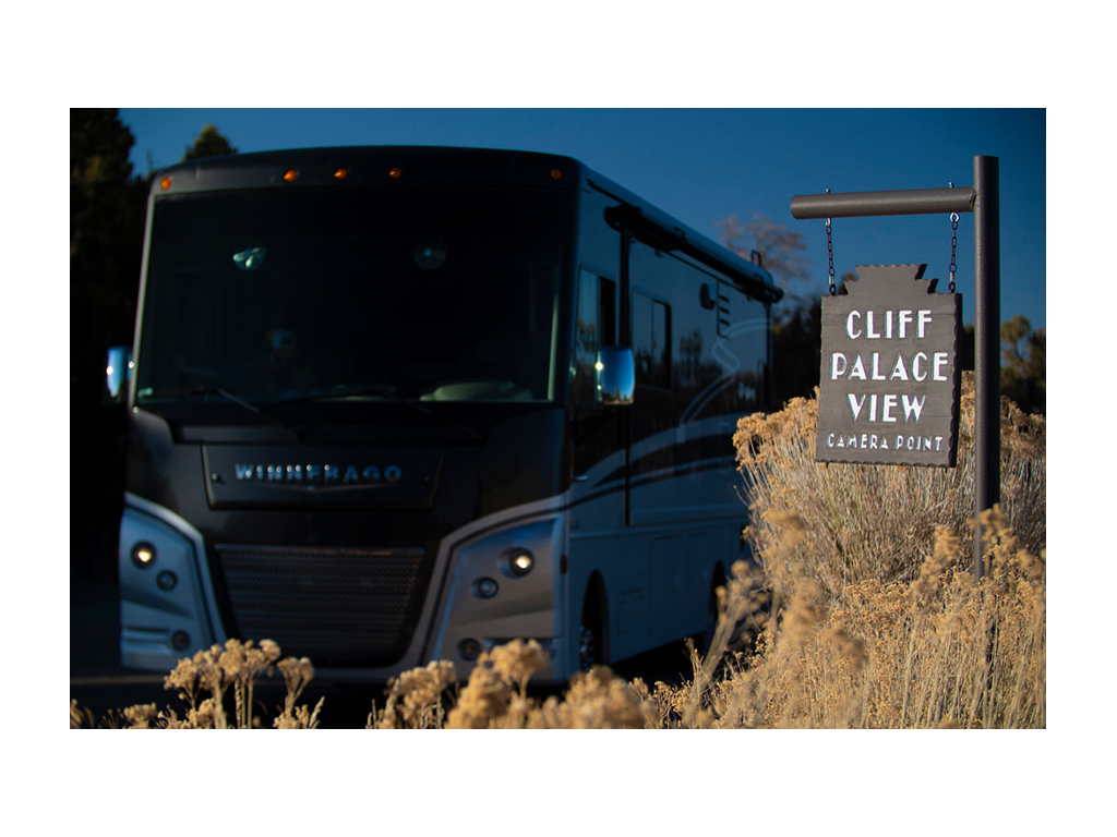 Adventurer next to Cliff Palace View sign