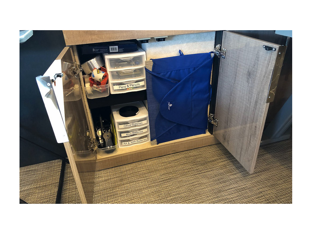 Plastic bins with white labels on them