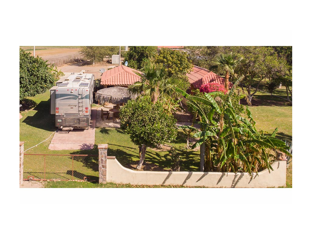 Journey parked next to house with fenced in yard