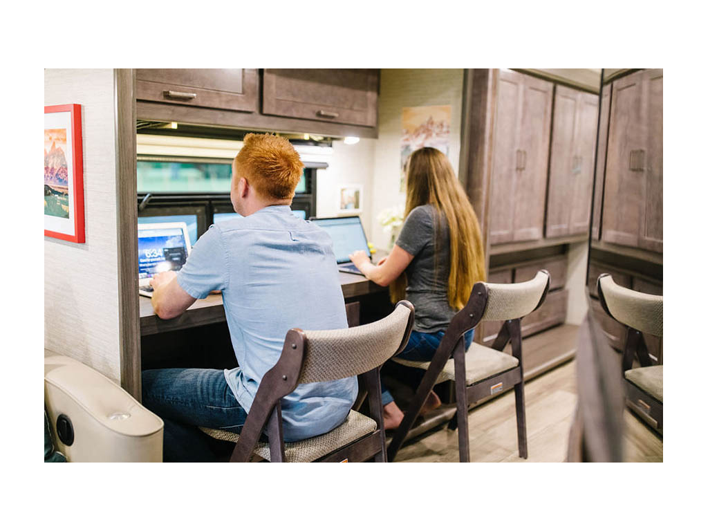 Heath and Alyssa working on laptops at hobby desk