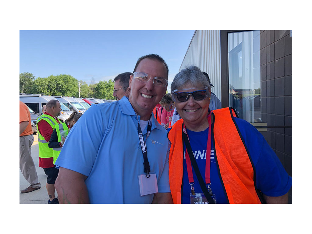 Sue Ann and Winnebago Employee smiling for a photo wearing safety glasses