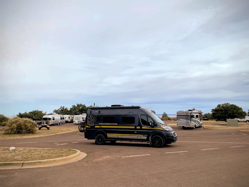 Winnebago Limited Edition National Park Foundation Travato parked in parking lot with other motorhomes in the background
