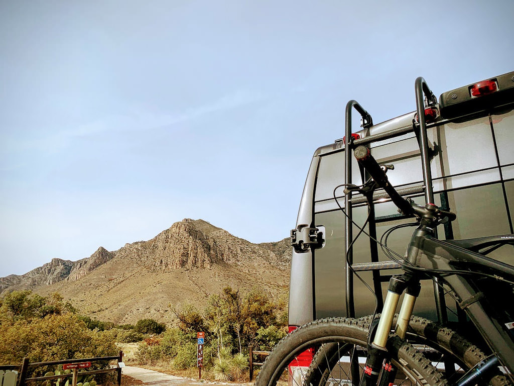 Back of Winnebago Limited Edition National Park Foundation Travato parked with the Guadalupe Mountains in the background