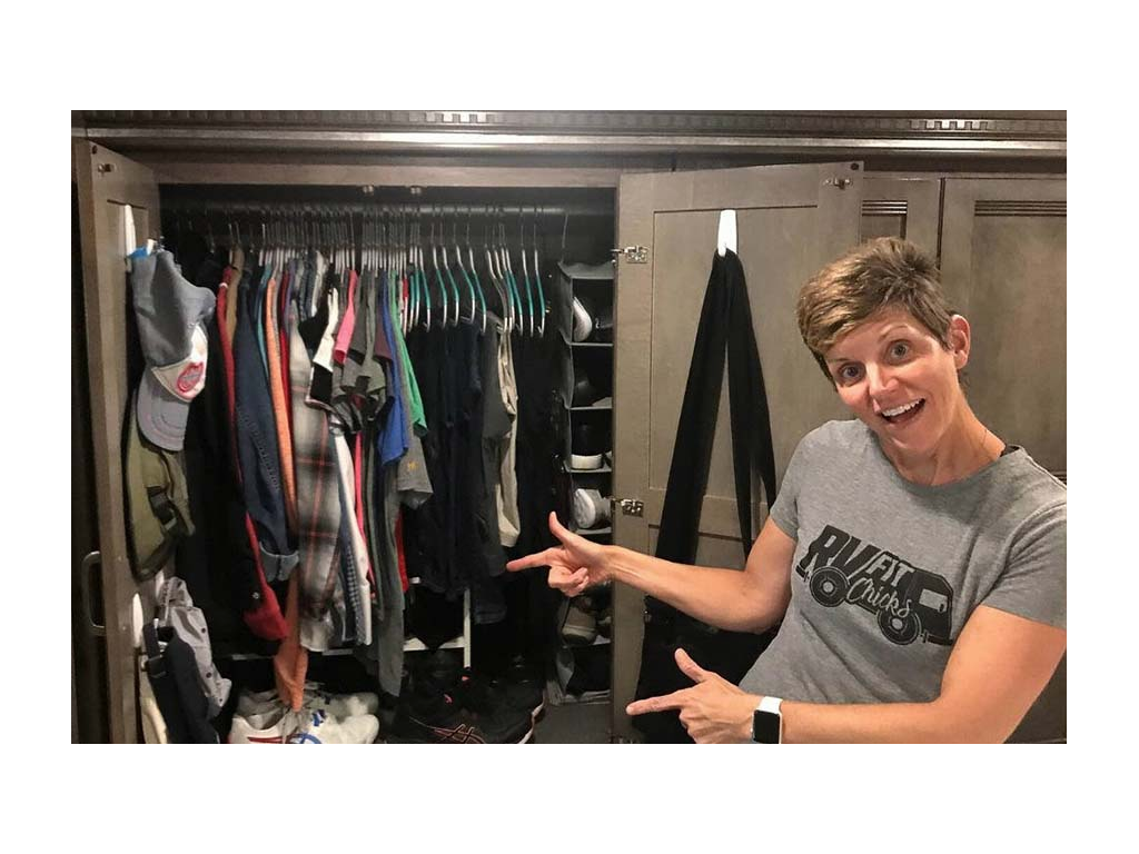 Ann pointing to closet full of clothes