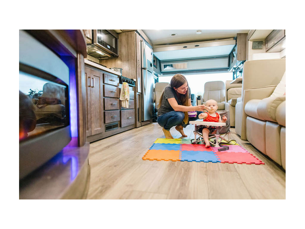 Alyssa feeding Ellie in kitchen of Forza
