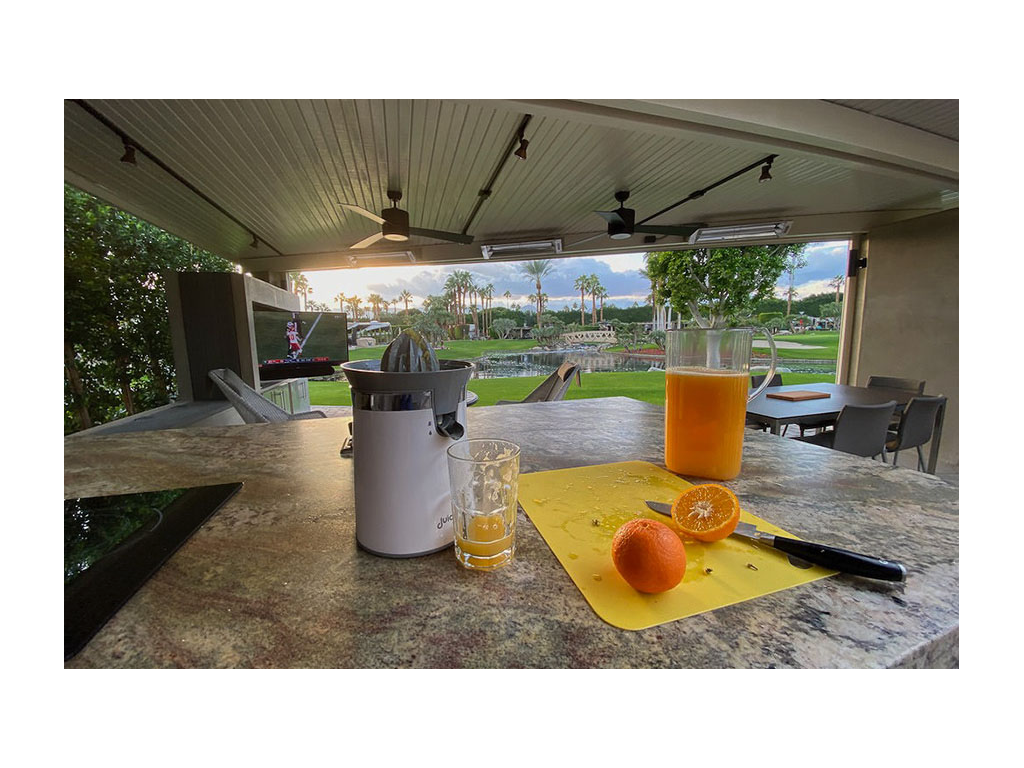 Freshly squeezed orange juice and oranges on the counter