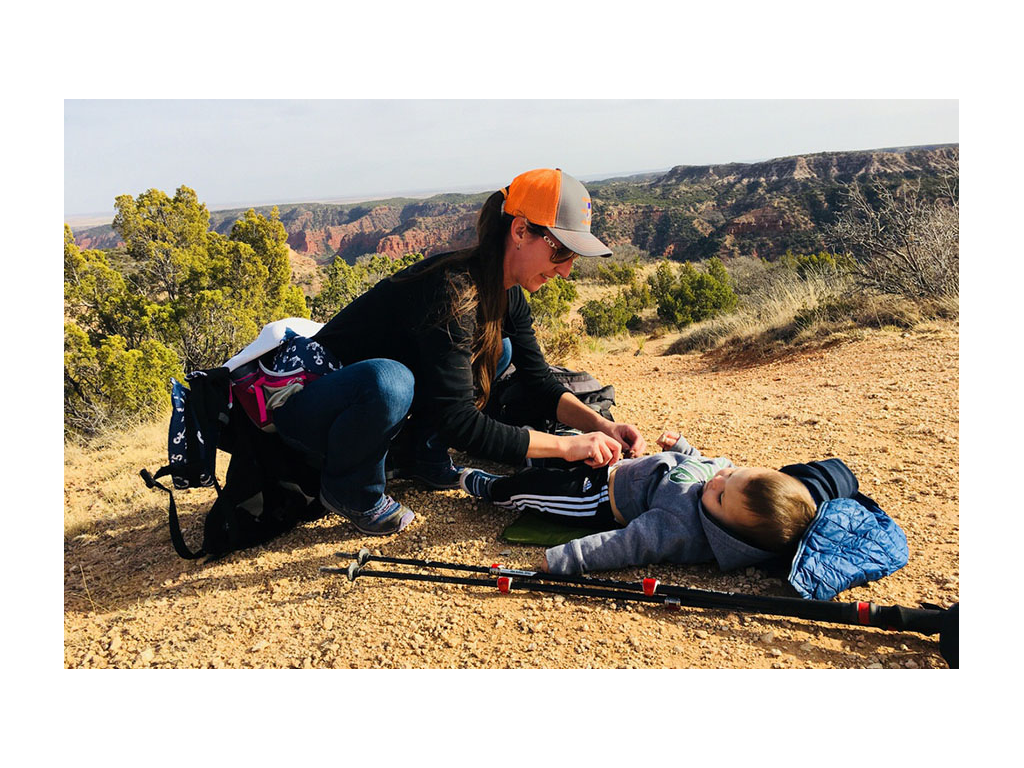 Brittany changing Caspian while hiking