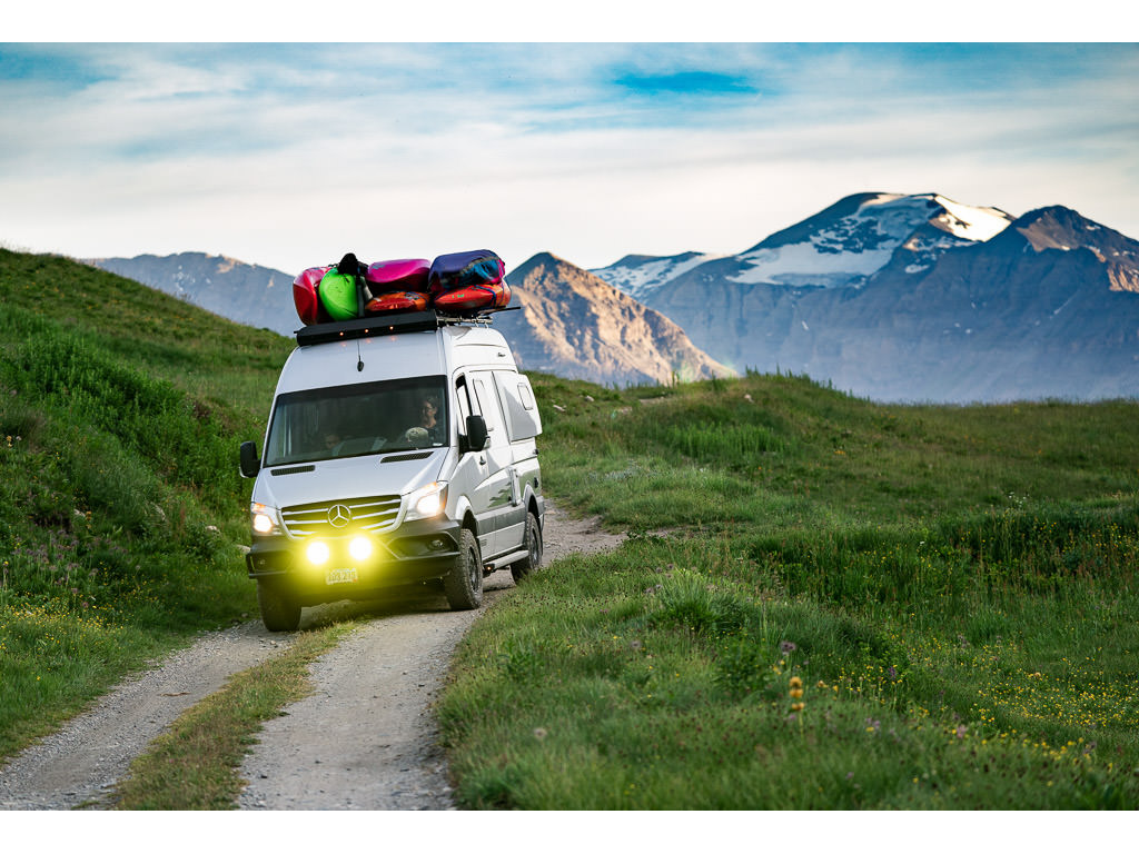 Winnebago Revel being driven on dirt road through the Swiss Alps