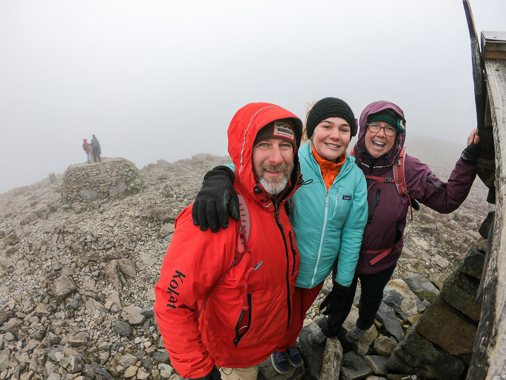 Holcombe family in sea of clouds at top of the mountains