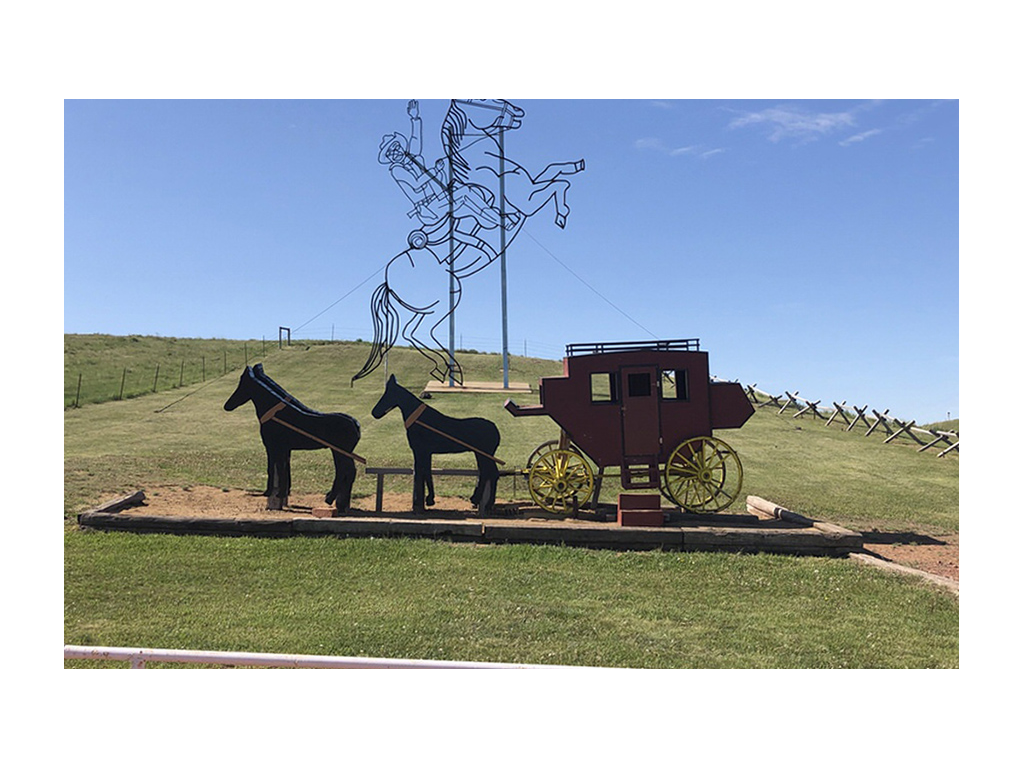 Teddy Rides Again sculptures. One sculpture is a stagecoach and the other of Roosevelt on his horse.