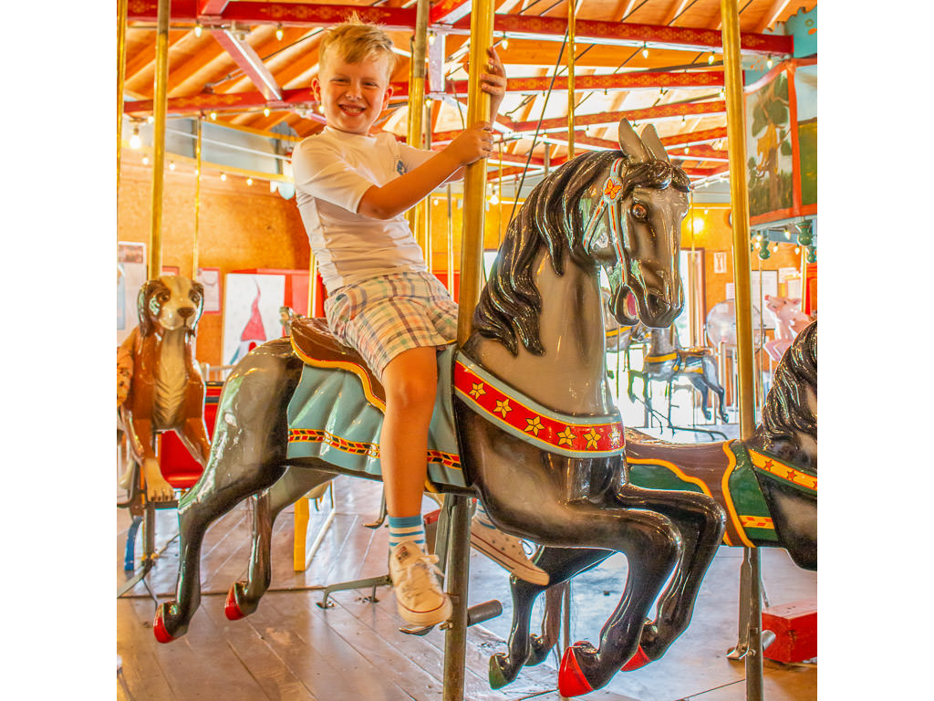 One of the boys on merry go round at Story City
