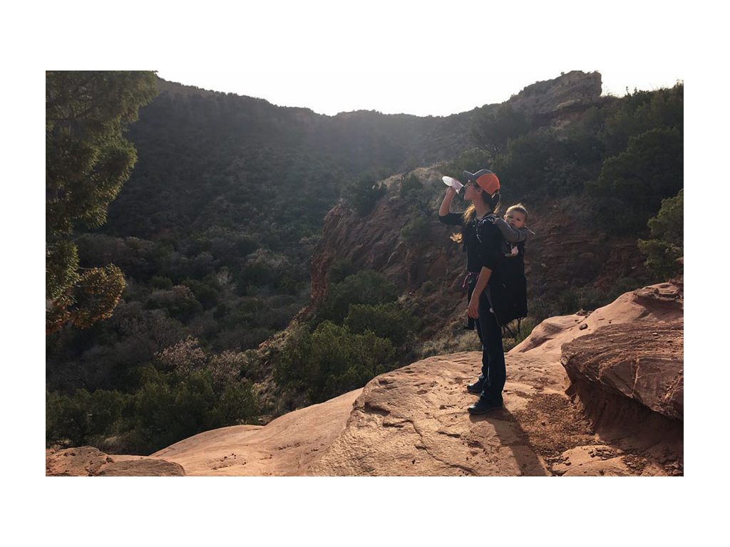 Brittany hiking with Caspian in kid's backpack