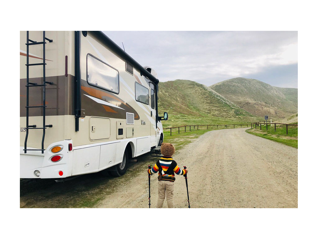 Caspian with hiking sticks standing next to Via