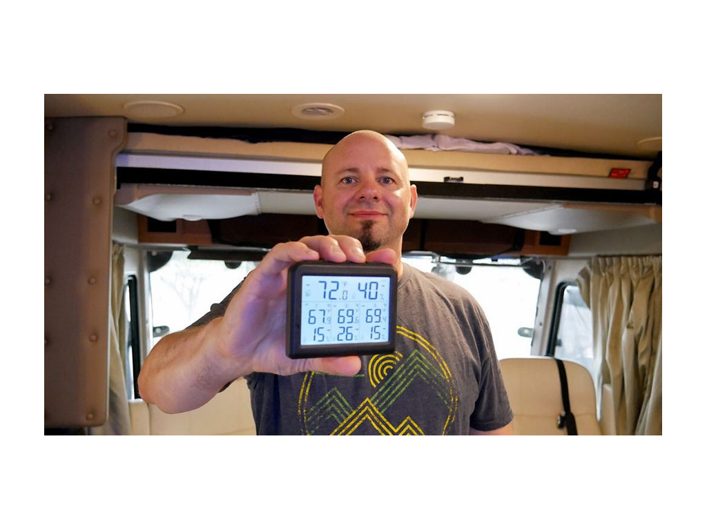 Kenny holding monitor showing humidity levels