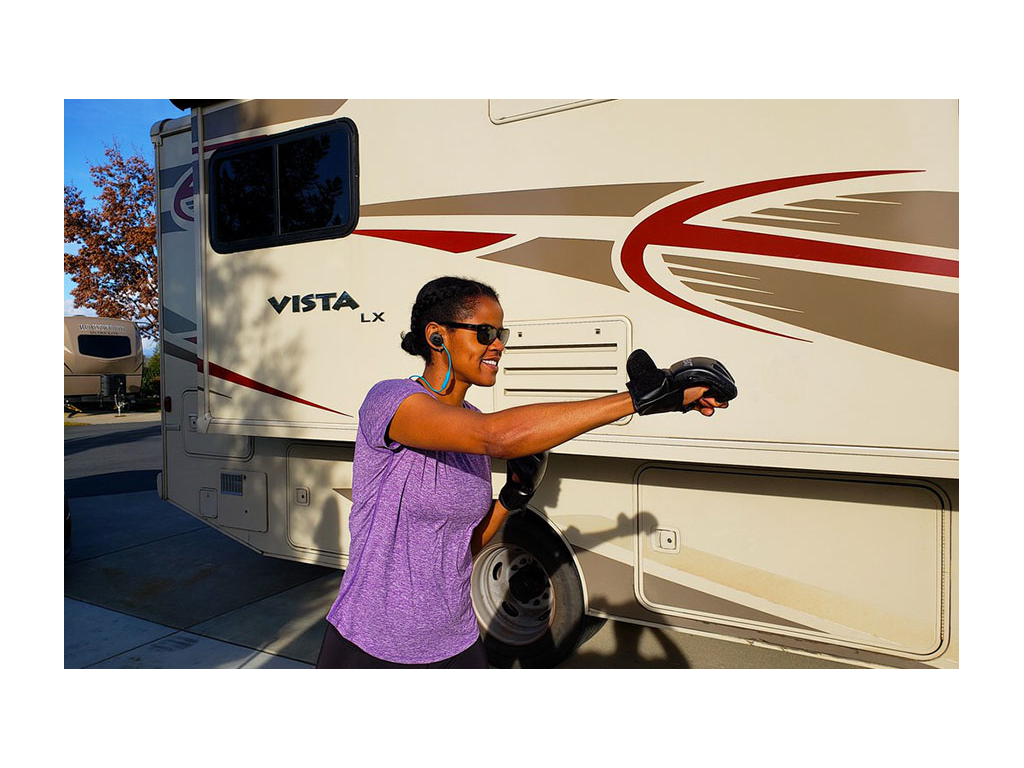 Sabrina wearing gloves doing a high-heintensity interval training (HIIT) workout next to Vista